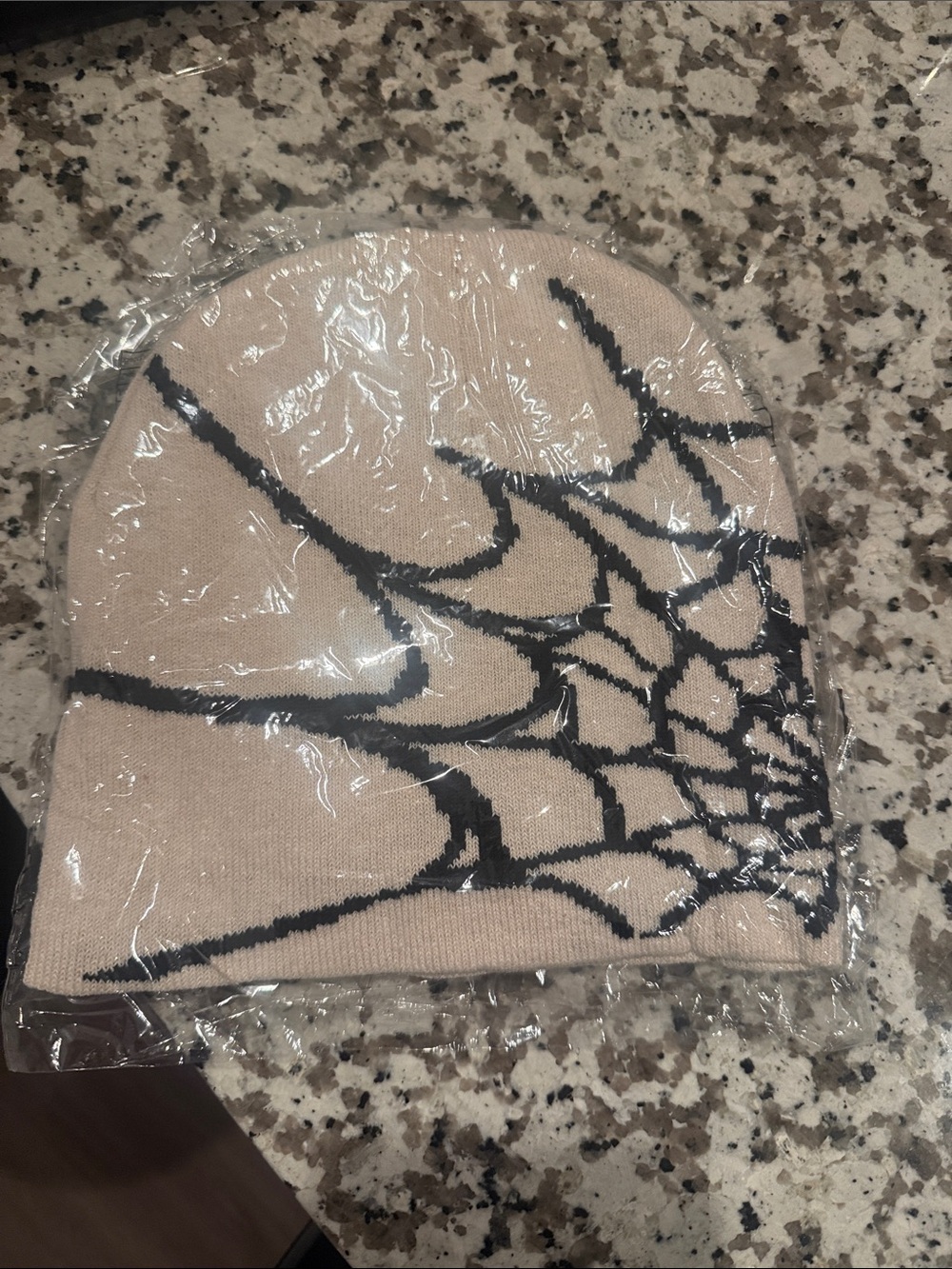 Beige Knit Beanie with Black Web Pattern